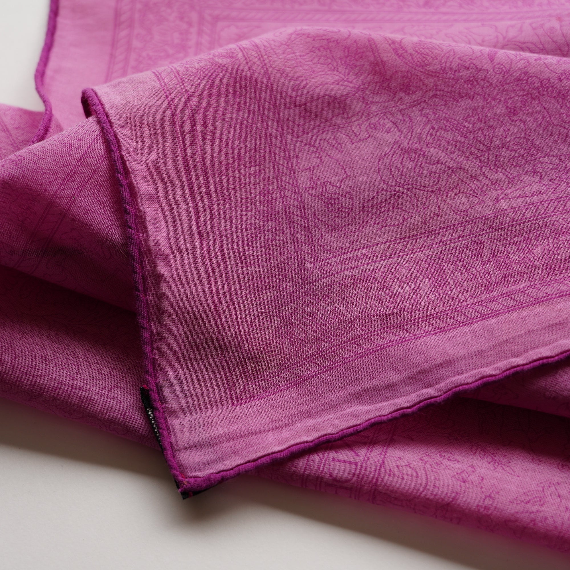 Détail technique de l'angle du foulard "Chasses Indiennes", montrant le roulotté main